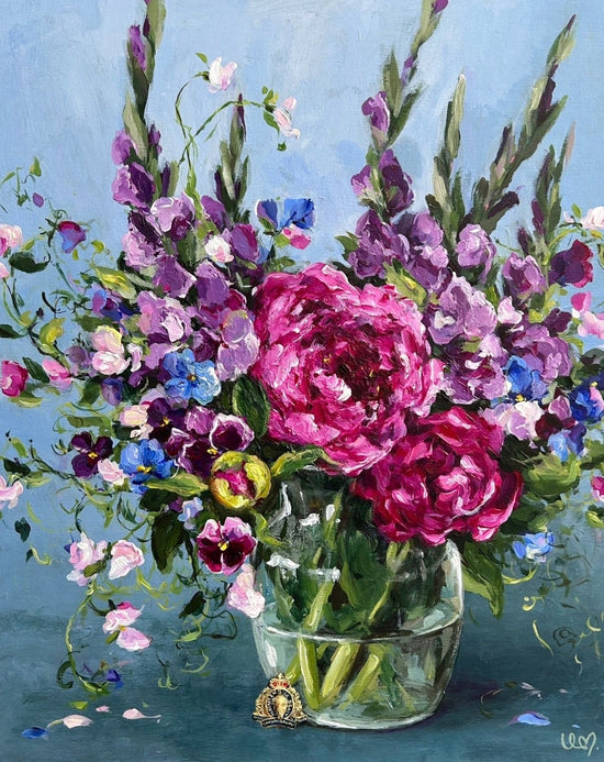 Bouquet of flowers in a glass vase on a blue background with family pin